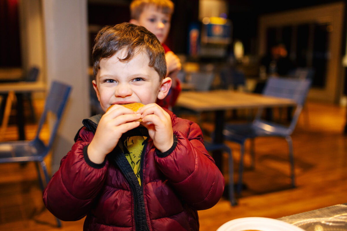 Young boy eating a cookie at Four Arrows Financial Group's Client Appreciation Event