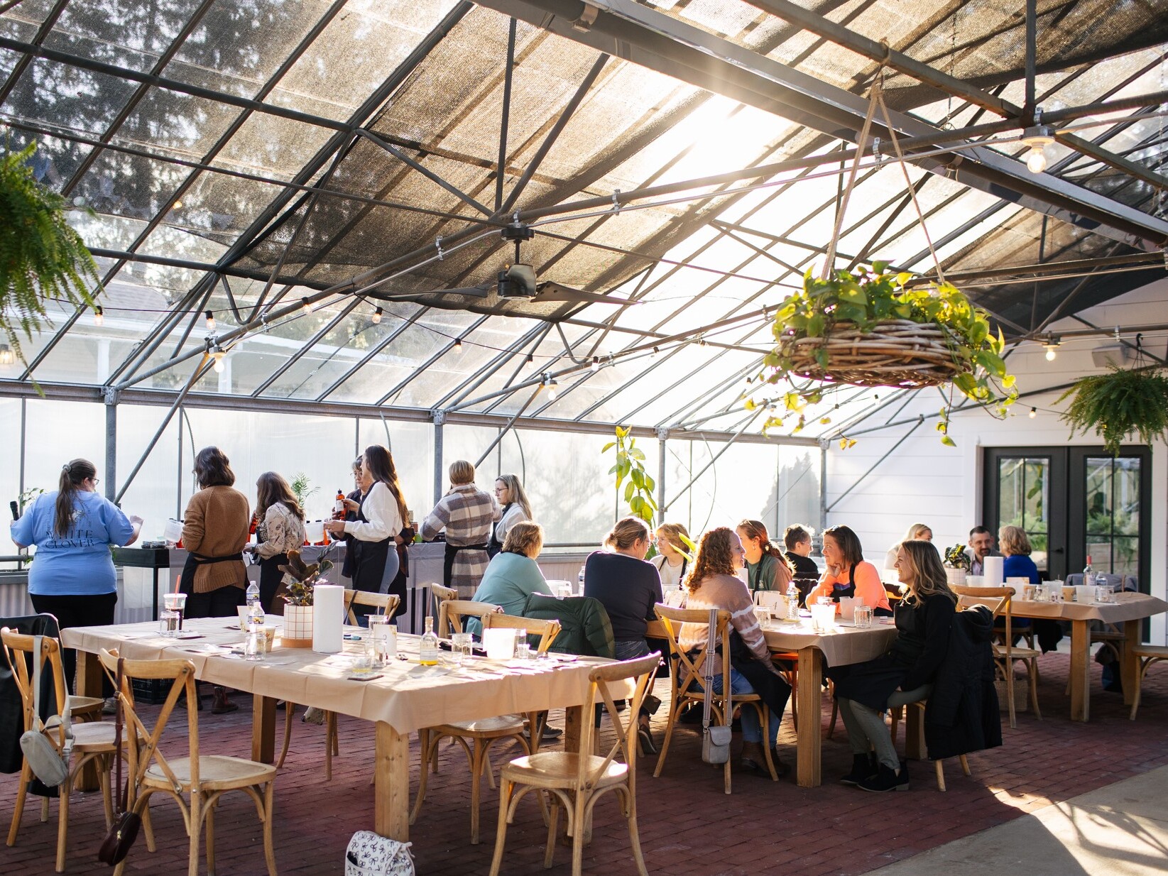 Women gathered around tables enjoying each other's company at Grayce Gardens