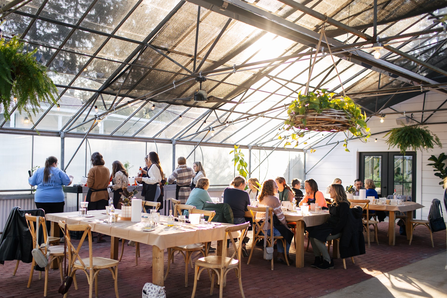Women gathered around tables enjoying each other's company at Grayce Gardens